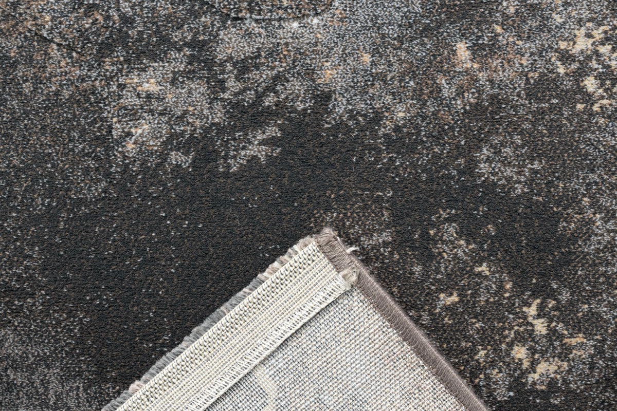 Coin replié montrant l'envers tissé du tapis gris Tapison Home Torino 063.0934.3293