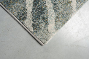 Détail d'un angle du tapis Tapison Home Torino 063.0990.4299 en vert et gris