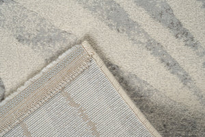 Coin replié montrant l'envers tissé du tapis ivoire Tapison Home Torino 063.0990.6797