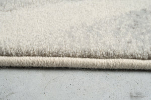 Vue de profil du velours ras et de la bordure du tapis Tapison Home Torino 063.0990.6797
