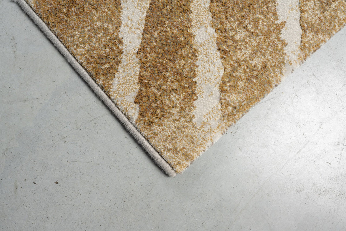 Détail d'un angle du tapis Tapison Home Torino 063.0990.7299 en ocre et ivoire