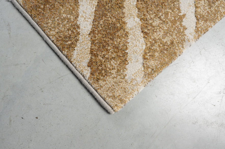 Détail d'un angle du tapis Tapison Home Torino 063.0990.7299 en ocre et ivoire
