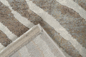 Coin replié montrant l'envers tissé du tapis taupe Tapison Home Torino 063.0990.9243