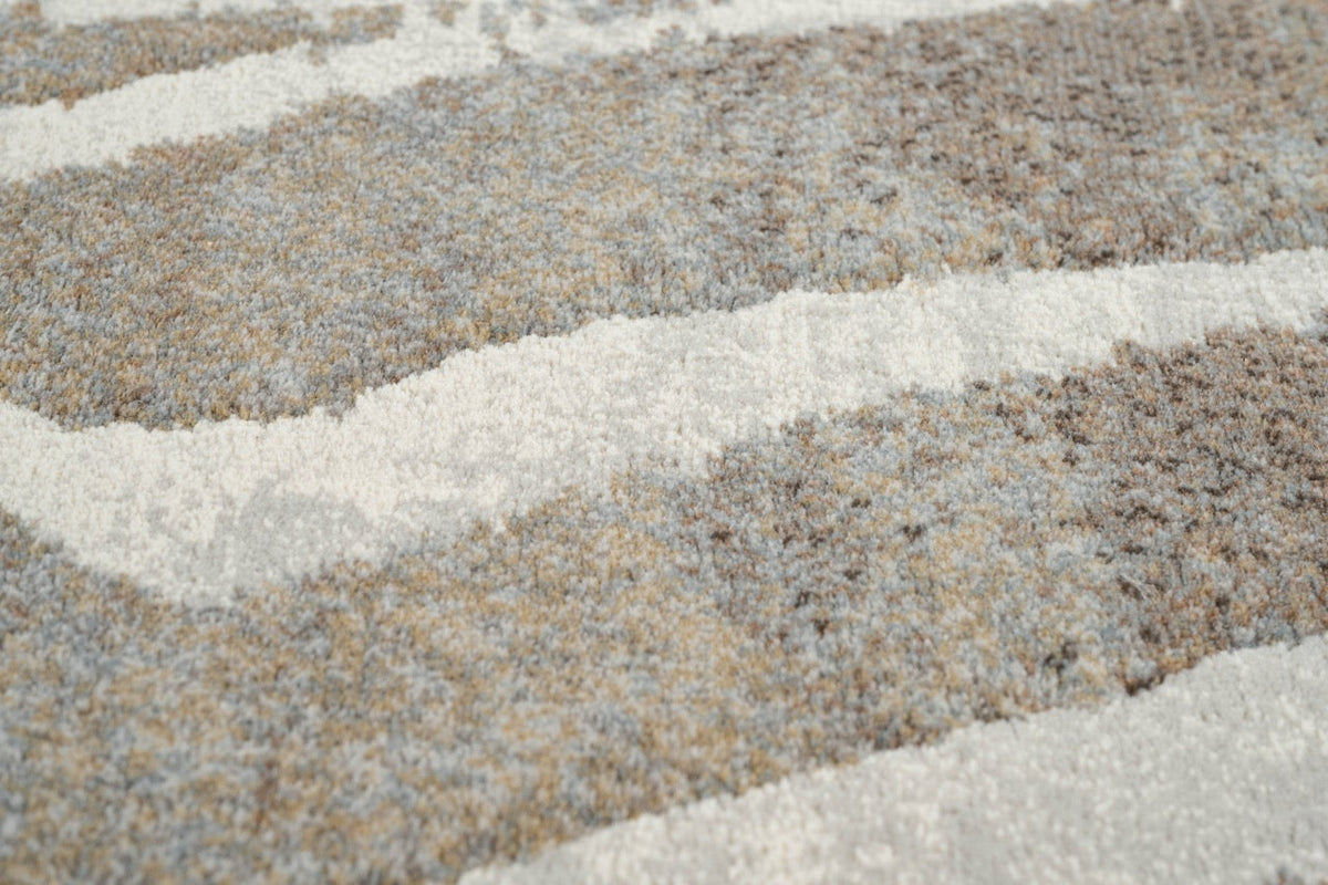 Gros plan sur le velours ras et dense du tapis Tapison Home Torino 063.0990.9243