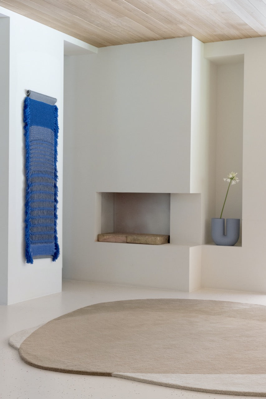  its sculpted surface features a series of softly carved abstract shapes — inspired by the fluid works of Jean Arp — that lend the rug subtle rhythm and sculptural expression.

The natural colourway combines ivory