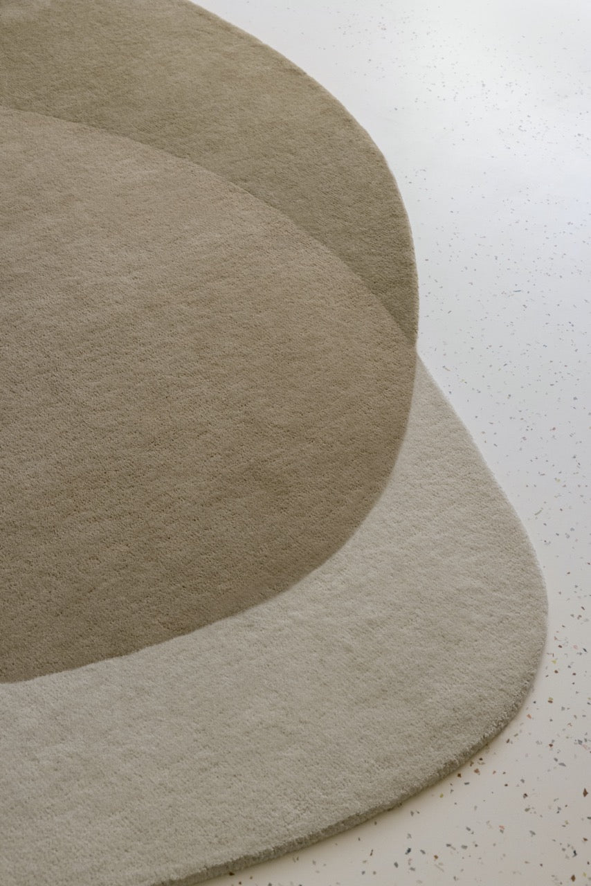  Close-up of carved relief on hand-tufted wool rug in ivory and stone