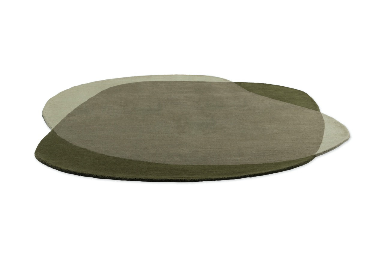  Abstract hand-tufted rug in forest and olive tones beneath oak coffee table