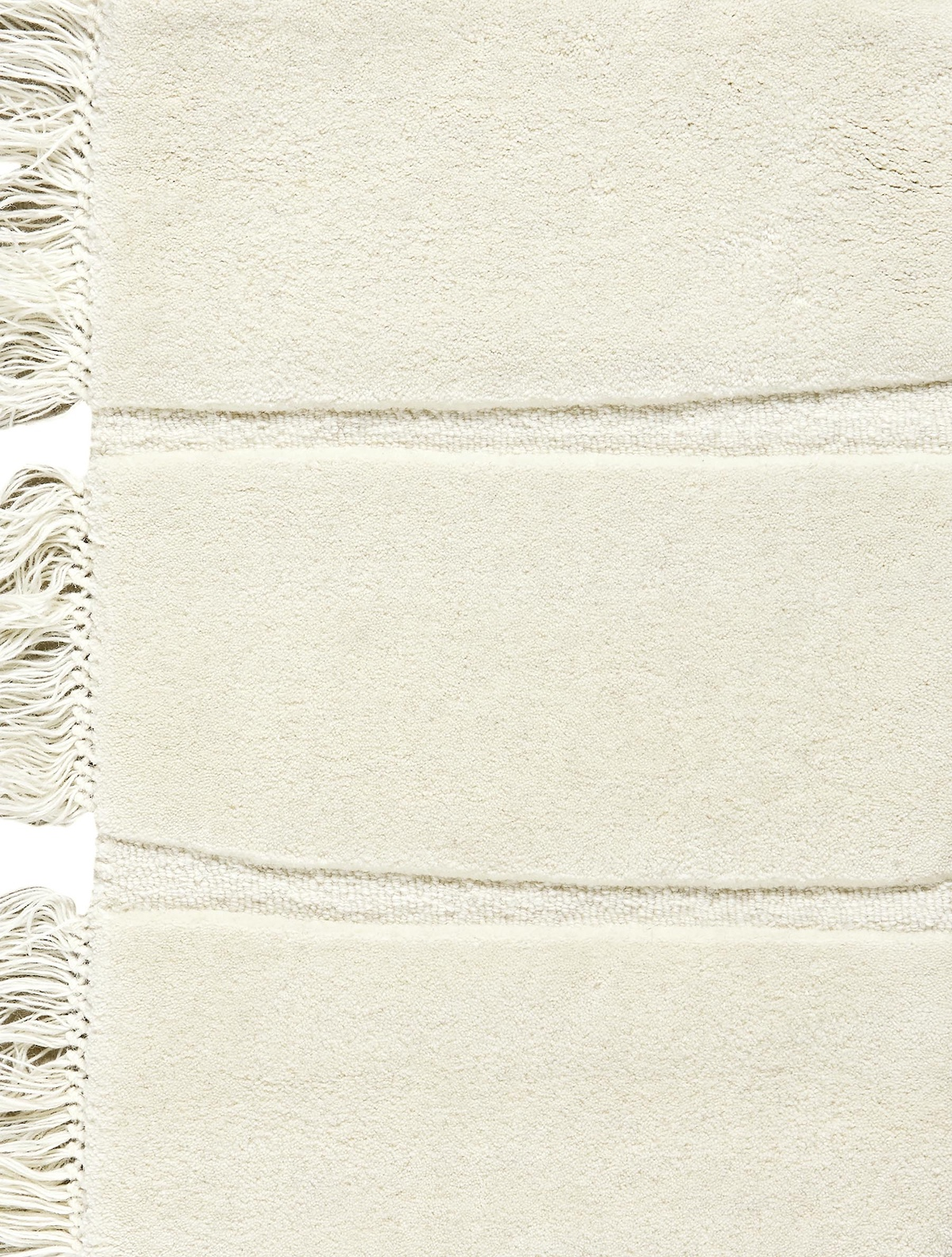 Massimo Atoll Cream tapis tufté en laine, détail des franges